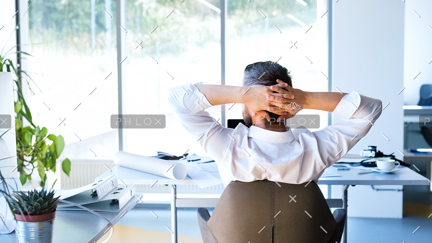 Businessman-at-the-desk-in-his-office-resting.