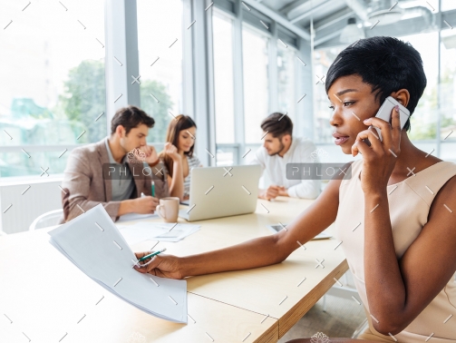 serious-businesswoman-with-documents-talking-on-P9Q6LX6